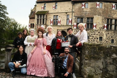 Gruppe von Schauspielenden in historischen Kostümen und Filmteam des Kurzfilms „Die Baronesse“ vor der Burg Vischering.