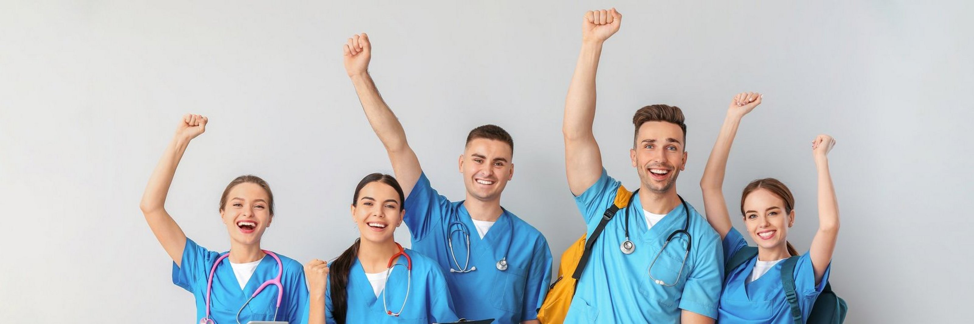 Group of happy medical students on light background